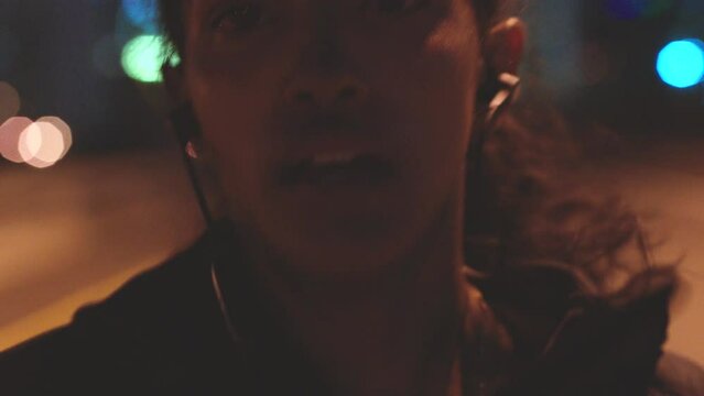 Fitness, exercise and woman running at night with energy on road, street or city. Fit, sweat and fast sport girl run, listen to workout motivation music and training for health, wellness or body goal