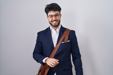 Hispanic man with beard wearing business clothes winking looking at the camera with sexy...