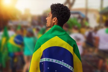 Fotobehang Brazil's Independence Day - Handsome Black Young Man Holding Brazil Flag on Cinematic Background © Andre Nery