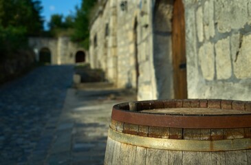 Naklejka premium Old, rustic wine barrel outdoor in front of wine cellar