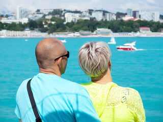 Fototapeta na wymiar Couple in love admiring the beautiful sea view