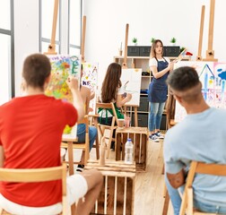 Group of people having paint lesson at art studio.