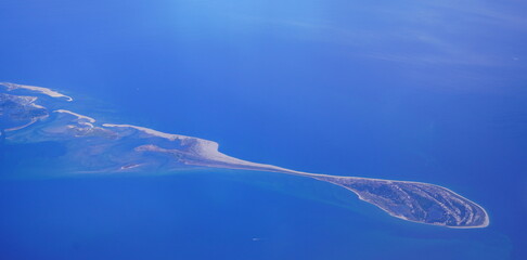 an aerial view of Cape Cod, city view and beach and ocean view from airplane. Cape Cod, a hook-shaped peninsula of the U.S. state of Massachusetts, is a popular summertime destination.