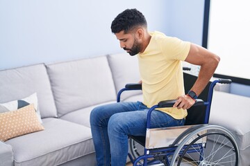 Young arab man sitting on wheelchair at street