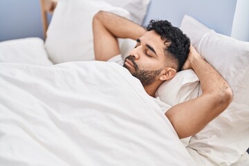 Fototapeta na wymiar Young hispanic man sleeping on bed at bedroom