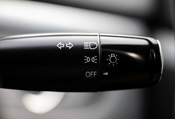 Turn signal lever, adjusting car headlight control switch.
