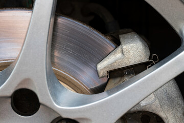 Rusted brake discs and traces of use of a small car, close-up.