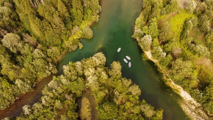 Two rivers coming together, some rafting boats.
