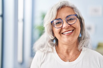 Middle age woman smiling confident standing at home