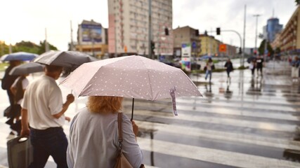 .People with umbrellas on a rainy day outside