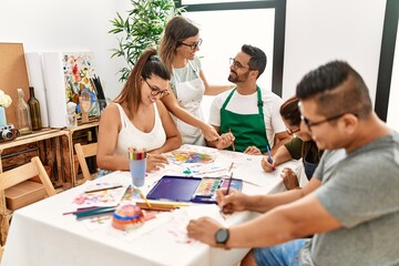 Group of draw students sitting on the table drawing at art studio.