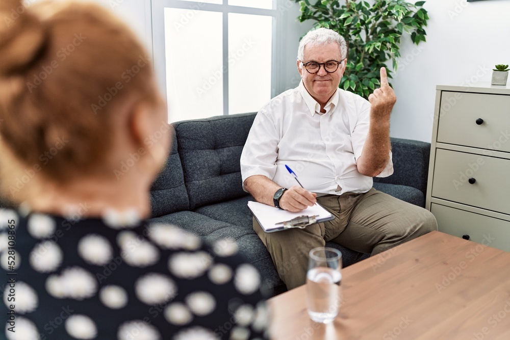 Canvas Prints Senior psychologist man at consultation office showing middle finger, impolite and rude fuck off expression