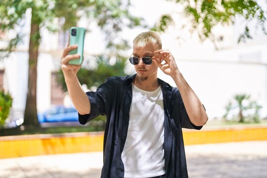 Young caucasian man making selfie by the smartphone at park