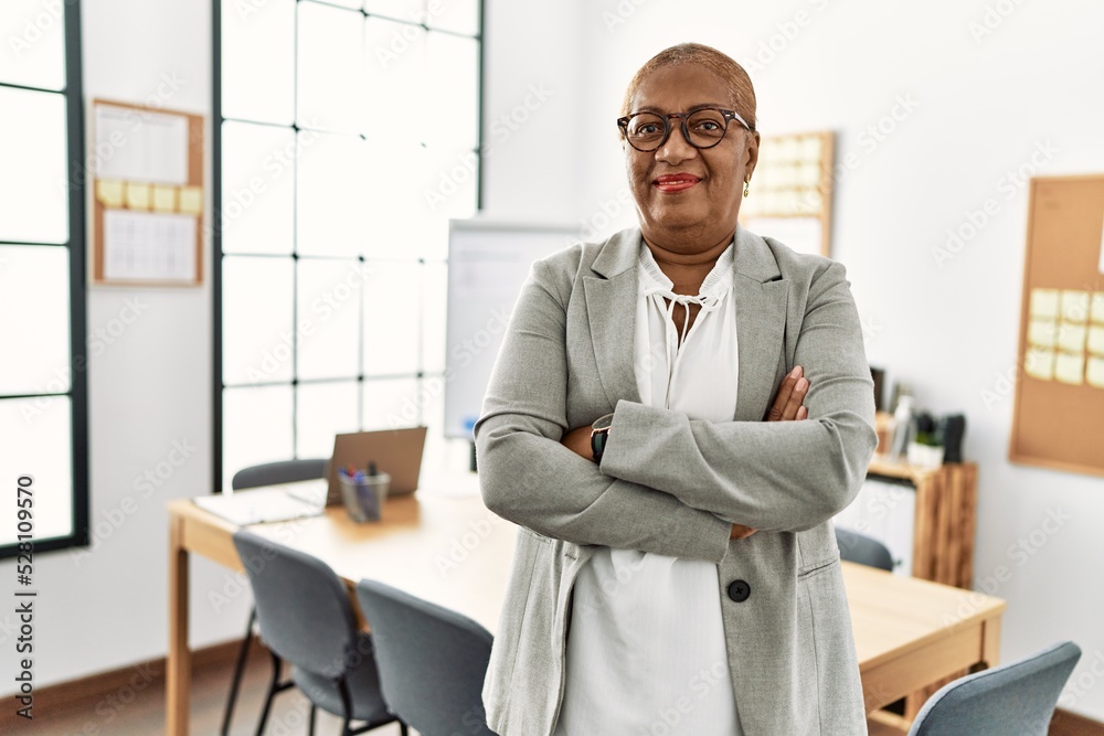 Poster Senior african american woman business worker standing with arms crossed gesture at office