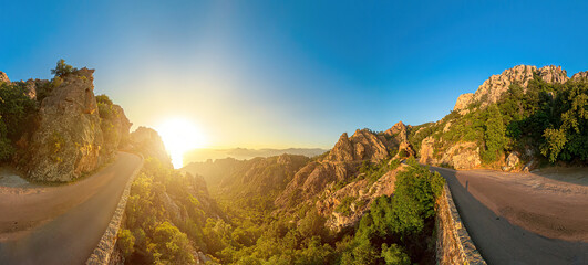 Aerial 360 degrees panorama on the road in Corsican badlands called Les Calanques in Mediterranean sea by the Porto Ota town. Aerial drone view of sunset badlands Calanques of Piana. UNESCO heritage. - obrazy, fototapety, plakaty