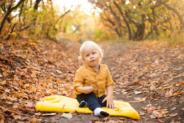 happy baby boy playing and laughing on autumn walk