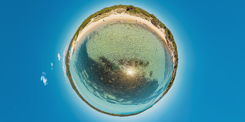 Tiny planet 360 view of the Mediterranean sea from Piantarella beach. Aerial view of the beach of Piana island in Corsica of France. Concept of environment with sea on cloudy sky background