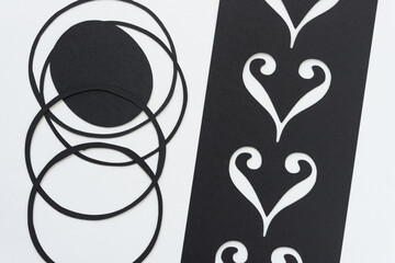 paper rings and oval with stencil and ornamental shapes on blank paper