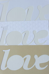 the word love represented with paper (three times love)