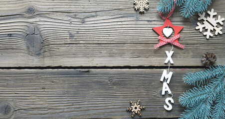 Christmas toys and tree branches on wooden background. New Years  concept. Xmas tree decoration, gift or greeting card. Copy space for our text