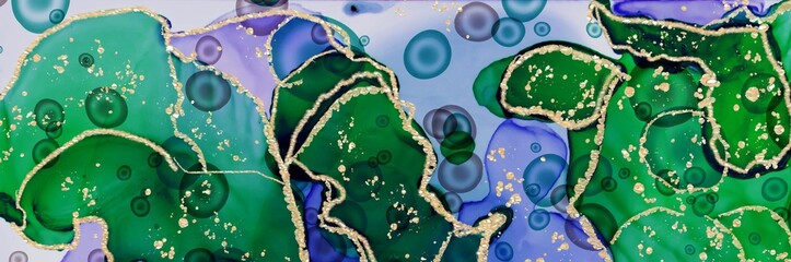 Deep blue and green areas with golden rings and lines on Alcohol ink fluid abstract texture fluid art with gold glitter and liquid.