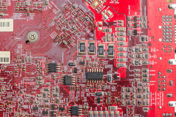 Graphics card printed circuit board on red textolite