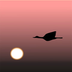 Silhouette of a goose flying against an autumn sunrise 
