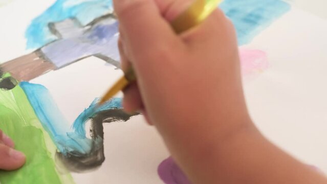 Close up Talented little girl Female Artist Draws Mother Sun Summer Flover drawing at Home. Colorful, Emotional Happy painting with Brush water colors. Contemporary Painter Creating Abstract Modern