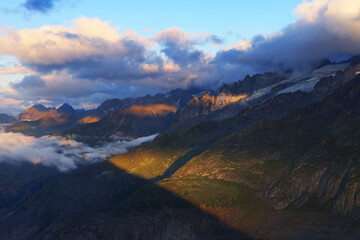 Naklejka na ściany i meble Summer cloudy landscape of the Berner Oberland Alps in Switzerland, Europe