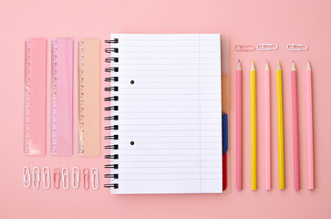 Back to school supplies shopping sale concept, stationery on pink background, flat lay, top view. Education accessories, pencils, rulers, open notebook geometric flatlay from above. Stationary ads