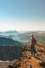 Tourist woman on cliff mountain outdoor Travel in Norway adventure trip active vacations healthy...