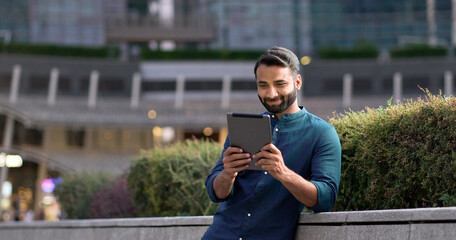 Smiling happy young indian business man professional, eastern latin businessman executive standing...
