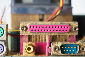 Old motherboard covered in dust and dirt. Close-up.