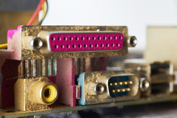 Old motherboard covered in dust and dirt. Close-up.