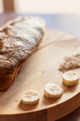 Banana and oat bread served on a wooden tray. Vegan, healthy, fresh.