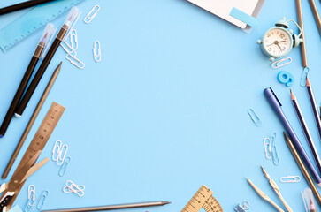 School supplies accessories stationery on blue background, flat lay, top view. Education stuff supplies accessories discount sales. Back to school concept. Flatlay frame from above. Copy space