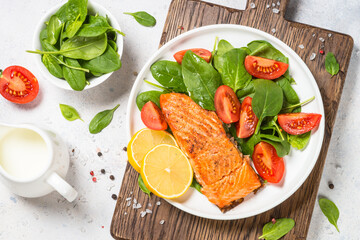 Salmon fillet with fresh salad. Healthy food, keto diet. Healthy lunch or dinner. Top view at white.