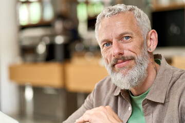 Happy smiling middle aged gray-haired man close up headshot. Older senior adult bearded male...