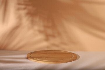 Minimal abstract background for the presentation of cosmetic products. Premium empty podium with shadows of tropical palm leaves on beige wall and wooden stand, template for design, pedestal podium,
