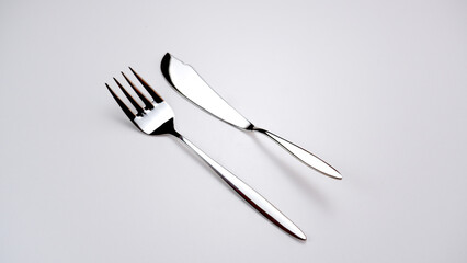 Silver fish fork knife service set photographed in an artistic way