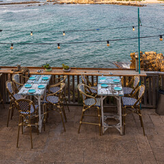 CAESAREA, Israel - August 11 2022, Hellena Restaurant Caesarea Harbor, tables and sea view