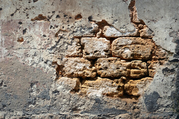 Brick wall wall with fallen off plaster