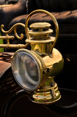 old brass headlight on vintage car