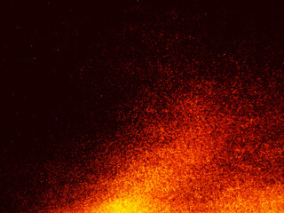 Fototapeta na wymiar Particles of embers of fire on a black background. Fire sparks background. Abstract lights of dark glitter fire particles.