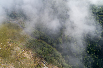 Aerial view of a mountain cliff in foggy weather