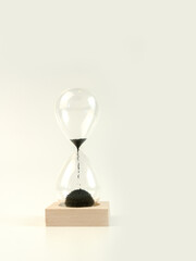 Hourglass on wooden stand isolated on white background.