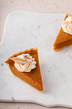 Pumpkin pie slices topped with whipped cream