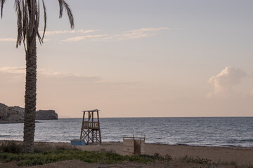Lifeguard tower on a greek beach at sunset. Empty beach in winter