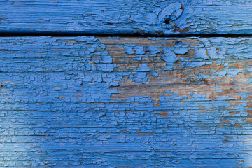 old blue painted wood as a cracked background