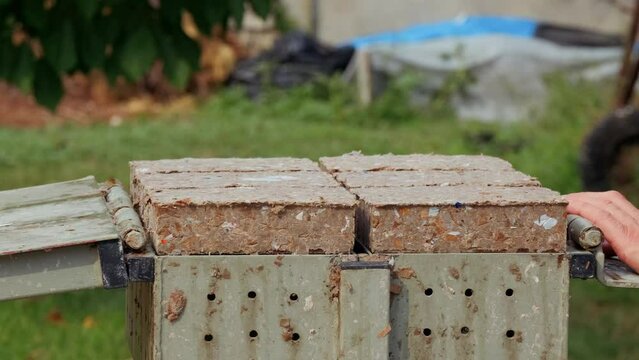 Making Pressed Paper Bricks from waste cardboards. ProRes 422HQ 12bit Mov. Energy crisis theme.